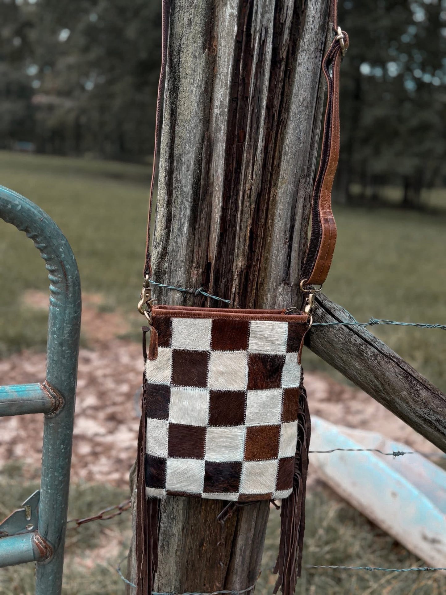 The small checkered cowhide fringe purse