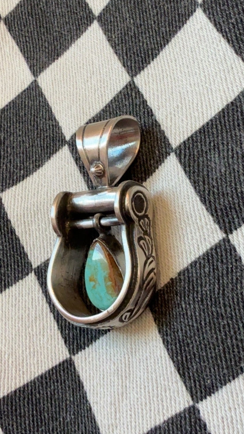 The cowgirl stirrup pendant