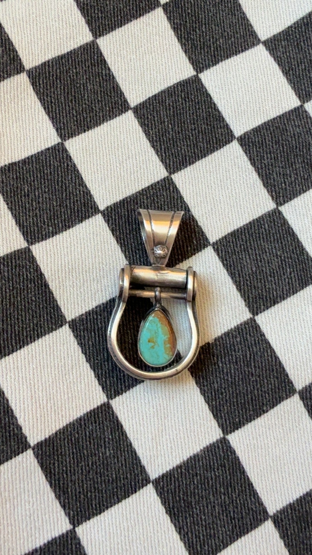 The cowgirl stirrup pendant